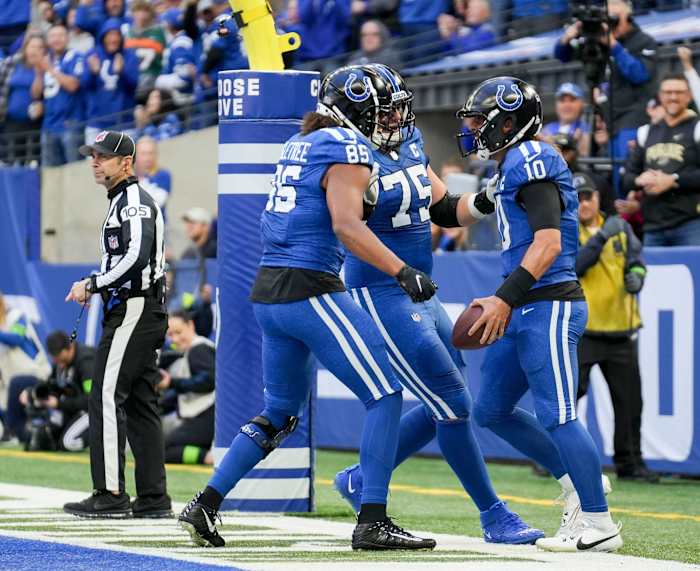 Indianapolis Colts quarterback Gardner Minshew II (10) celebrates with Indianapolis Colts guard Will Fries (75) and Indianapolis Colts tight end Drew Ogletree (85) after rushing for a touchdown Sunday, Oct. 22, 2023, during a game against the Cleveland Browns at Lucas Oil Stadium in Indianapolis.  
